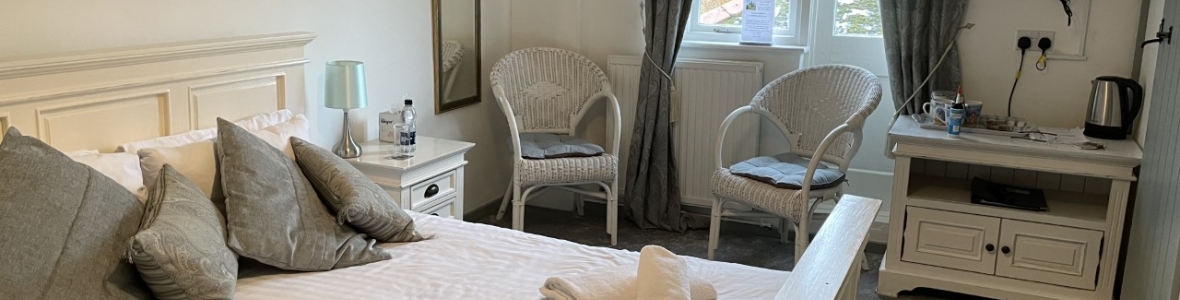 Family room with double bed tv curtains and mirror